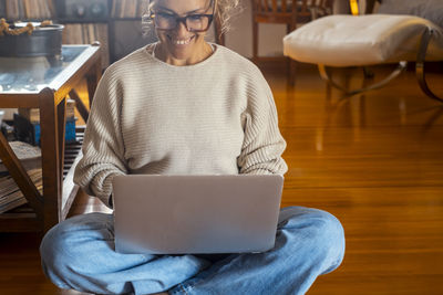 Portrait of woman using laptop at home