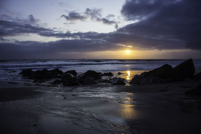 Scenic view of beach against sky during sunset