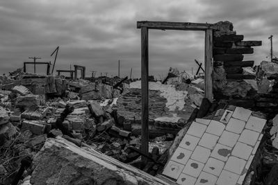 Damaged cars in city against sky