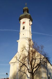 Low angle view of lighthouse against blue sky