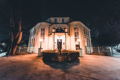 Statue of illuminated building at night