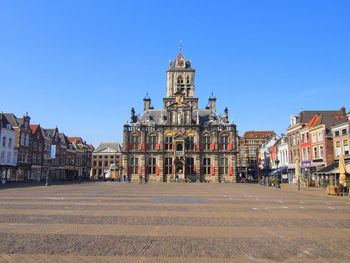 Building in city against clear blue sky