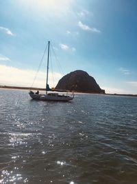 Sailboat sailing on sea against sky