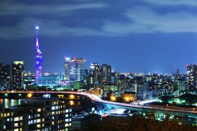 Illuminated cityscape against sky at night