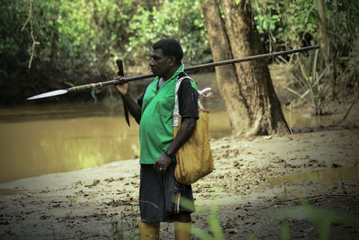 A father is working in debt in papua to earn a living with his family.