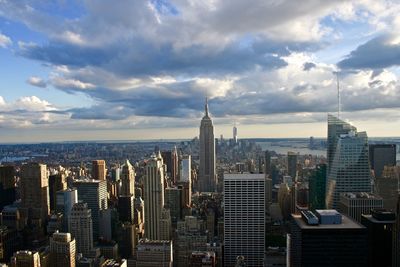 Empire state building amidst towers at manhattan