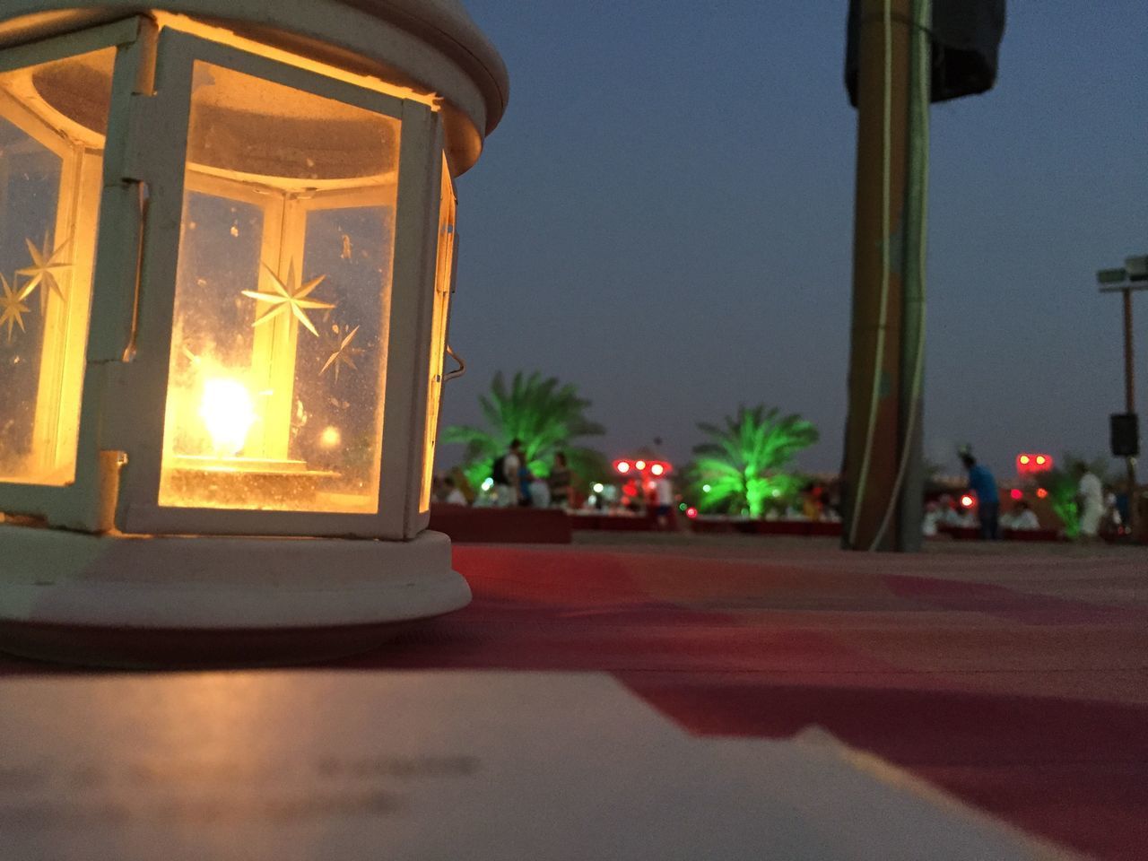 CLOSE-UP OF ILLUMINATED LAMP AGAINST SKY