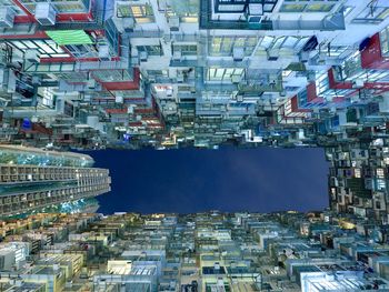 Directly below shot of illuminated buildings in city at night