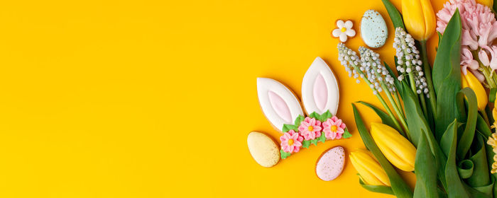 Close-up of christmas decorations on yellow background