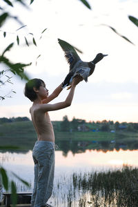 Full length of man standing in lake against sky