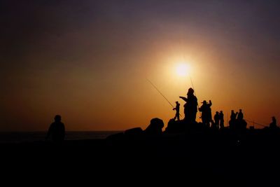 Silhouette people at sunset