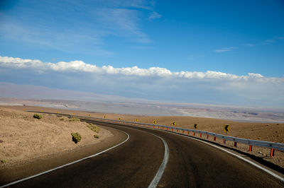 Empty road along trees