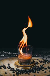 Close-up of burning candle on table