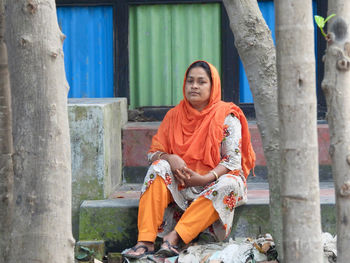 Portrait of young woman sitting on stairs 