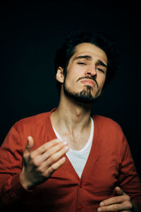 Man standing against black background