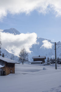 Scenic view of snow covered mountains against sky