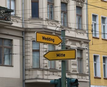 Low angle view of road sign against building