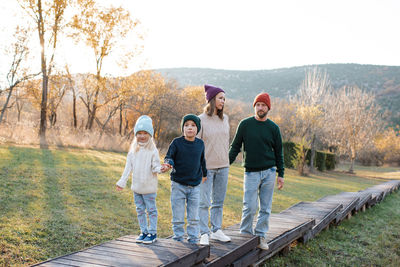 Rear view of couple walking on road