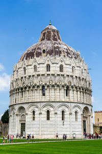 Tourists in front of church against clear sky