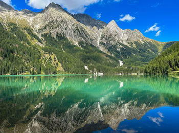 Scenic view of lake and mountains against sky