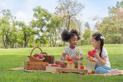 Children playing in basket on grass