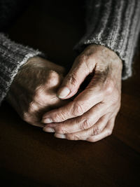 Close up of senior woman hands on table