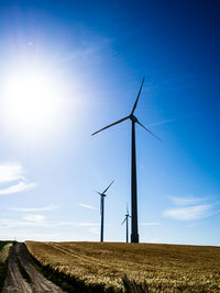 Windmill on field against sky