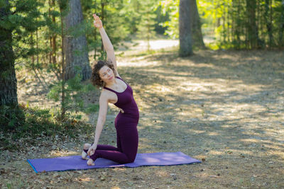 Side view of woman exercising in park