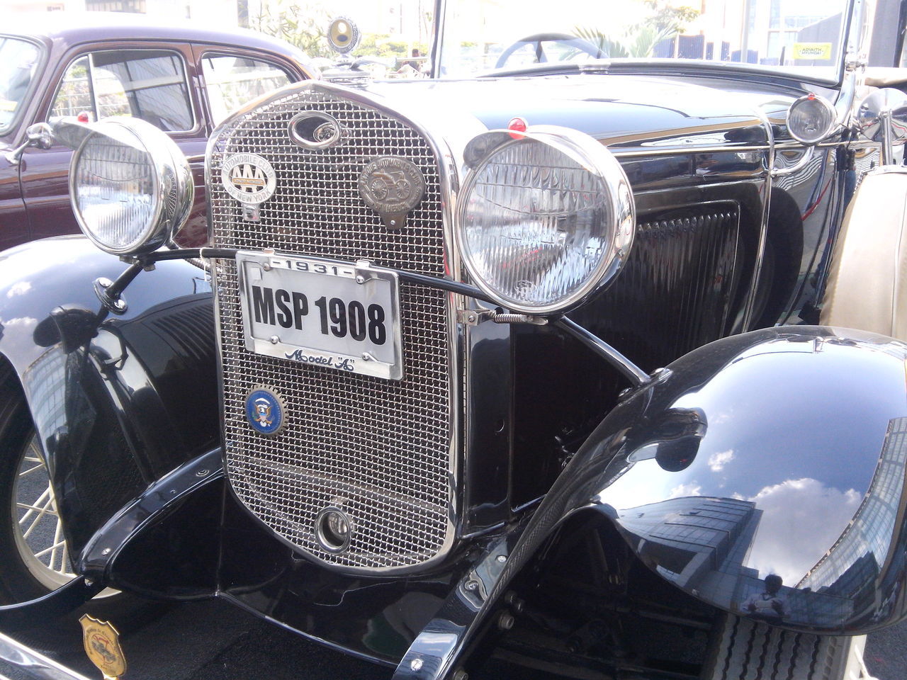 CLOSE-UP OF CARS ON MOTORCYCLE AGAINST BLURRED BACKGROUND