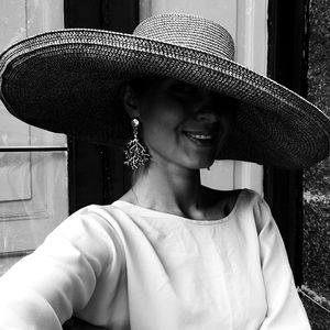 Close-up of smiling woman wearing hat