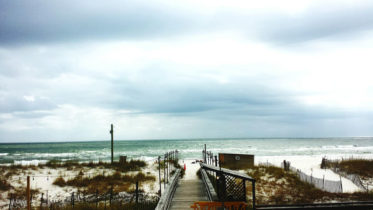 sea, horizon over water, water, sky, beach, scenics, shore, cloud - sky, tranquil scene, beauty in nature, tranquility, railing, pier, nature, idyllic, cloudy, incidental people, sand, cloud, outdoors