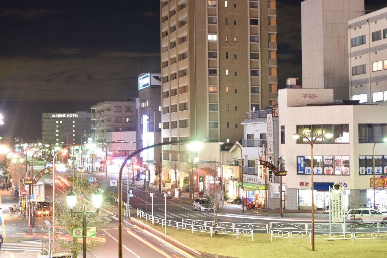 VIEW OF ILLUMINATED CITY AT NIGHT