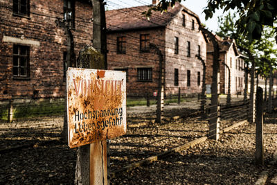 Close-up of road sign against built structure