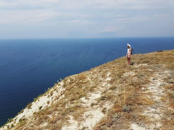 Man looking at sea against sky