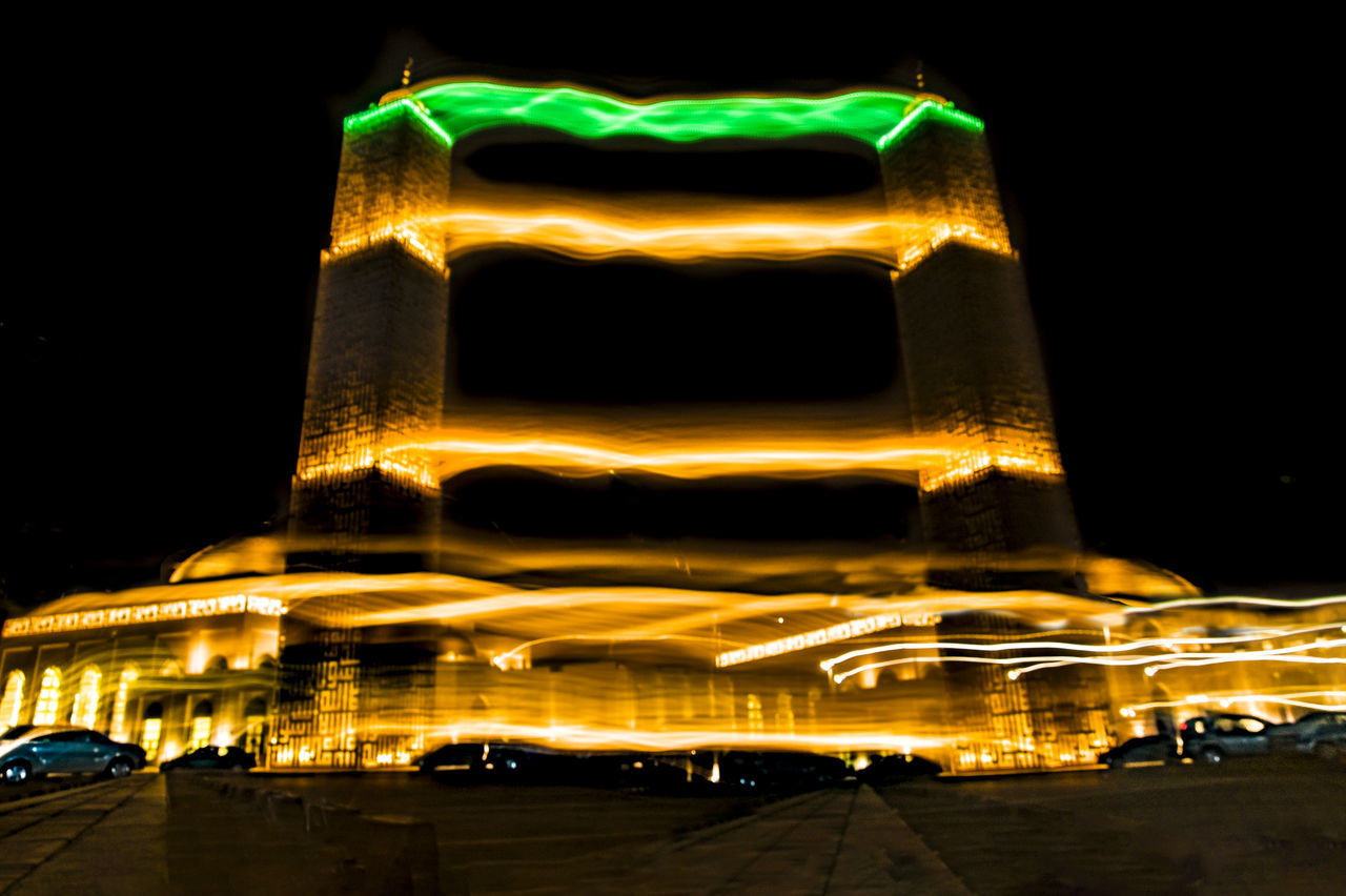 CLOSE-UP OF ILLUMINATED STATUE AGAINST SKY AT NIGHT