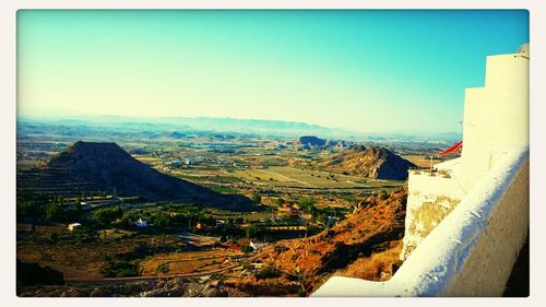 Scenic view of mountains against clear blue sky