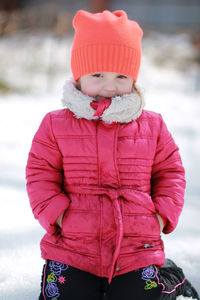 Cute girl standing in snow