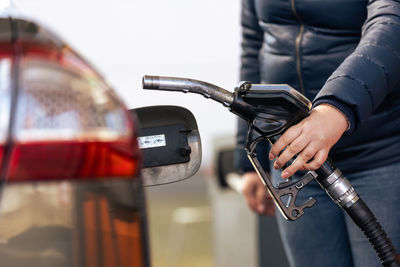 Midsection of man holding car