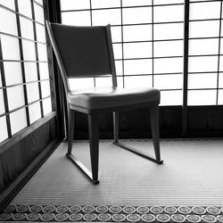 Empty chairs and table in building