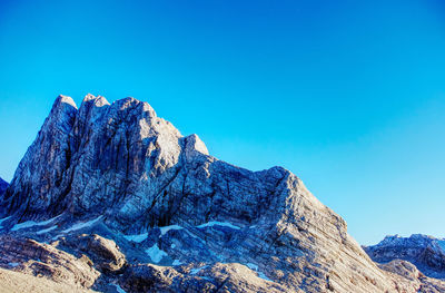 Scenic view of mountains against clear blue sky