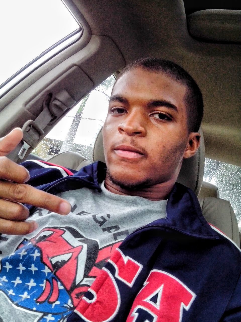 lifestyles, leisure activity, person, transportation, young men, casual clothing, indoors, mode of transport, vehicle interior, car, young adult, communication, land vehicle, front view, men, headshot, looking at camera, portrait