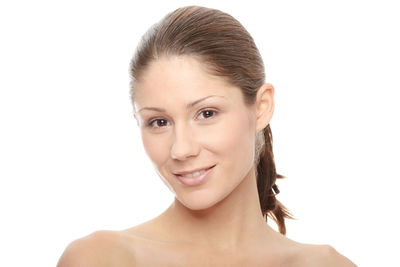 Portrait of smiling young woman against white background