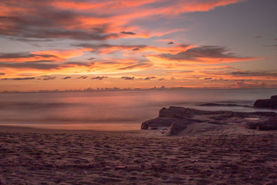 Scenic view of sea against orange sky