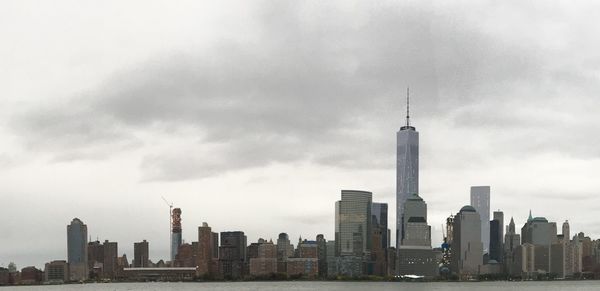 City skyline against cloudy sky