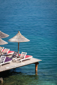 High angle view of lounge chairs by sea