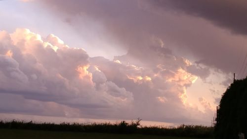 Scenic view of field against sky at sunset