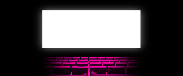 Close-up of empty chairs against black background