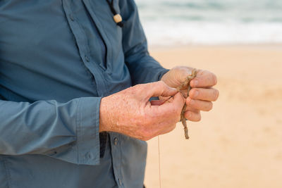 Close-up of man holding hands