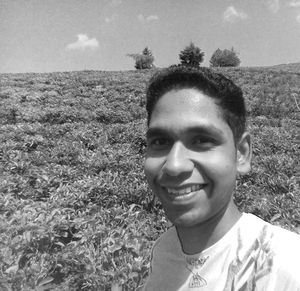 Portrait of smiling young man on field