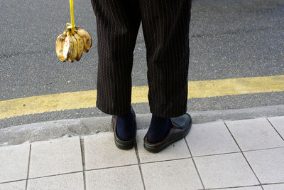 Low section of man wearing shoes